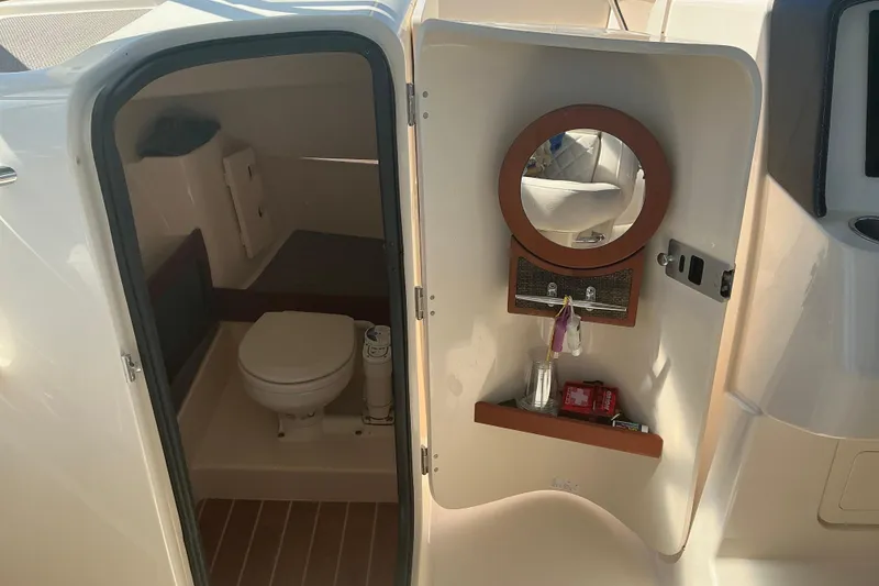 Slide: The Image of 2020 Grady-White Freedom 285 boat interior with toilet and mirror. - 17