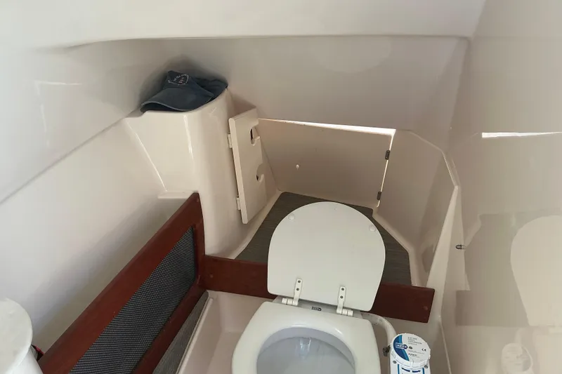 Slide: The Image of 2020 Grady-White Freedom 285 boat interior with toilet and storage area. - 18