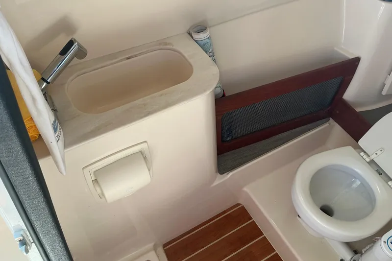 Slide: The Image of 2020 Grady-White Freedom 285 boat bathroom with sink and toilet. - 19
