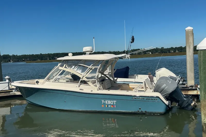 Slide: The Image of 2020 Grady-White Freedom 285 boat docked by the water. - 2