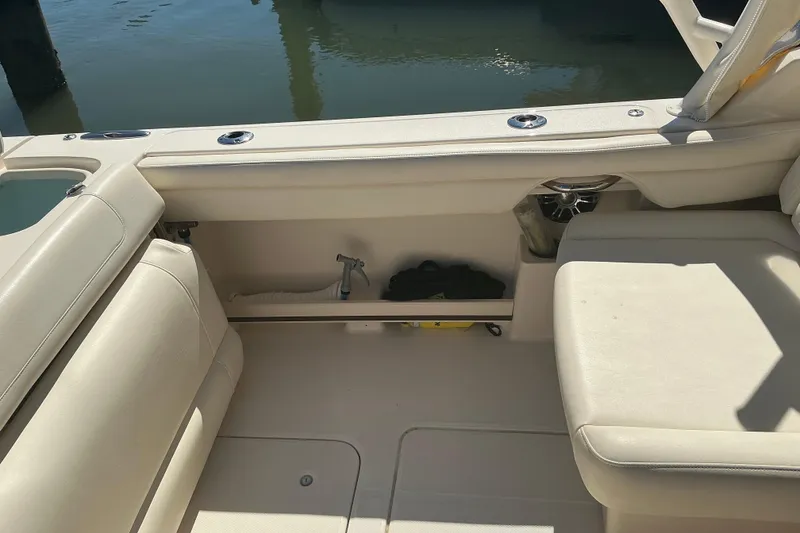 Slide: The Image of 2020 Grady-White Freedom 285 boat interior with beige seating and storage compartment. - 22