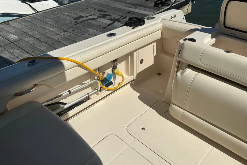 Slide: The Image of 2020 Grady-White Freedom 285 boat interior with seating and dock view. - 23