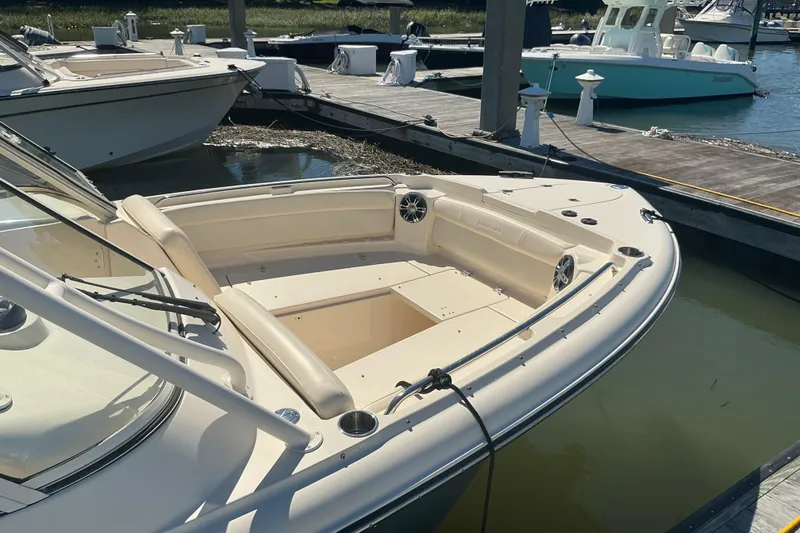 Slide: The Image of 2020 Grady-White Freedom 285 boat docked at marina, showcasing spacious seating area. - 7