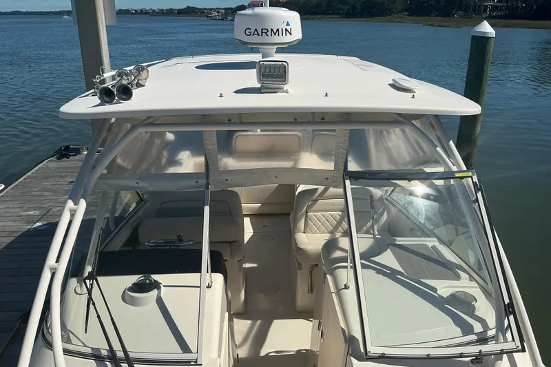 Slide: The Image of 2020 Grady-White Freedom 285 boat docked, featuring Garmin equipment and spacious seating. - 8