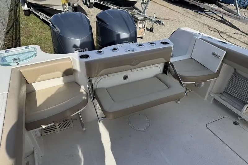 Slide: The Image of 2021 Sailfish 290 CC boat interior with seating and dual outboard motors. - 17