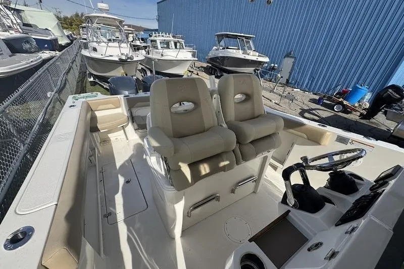 Slide: The Image of 2021 Sailfish 290 CC boat interior with dual seats and steering console. - 19