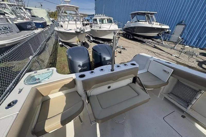 Slide: The Image of 2021 Sailfish 290 CC boat interior with seating and dual 250 engines. - 20