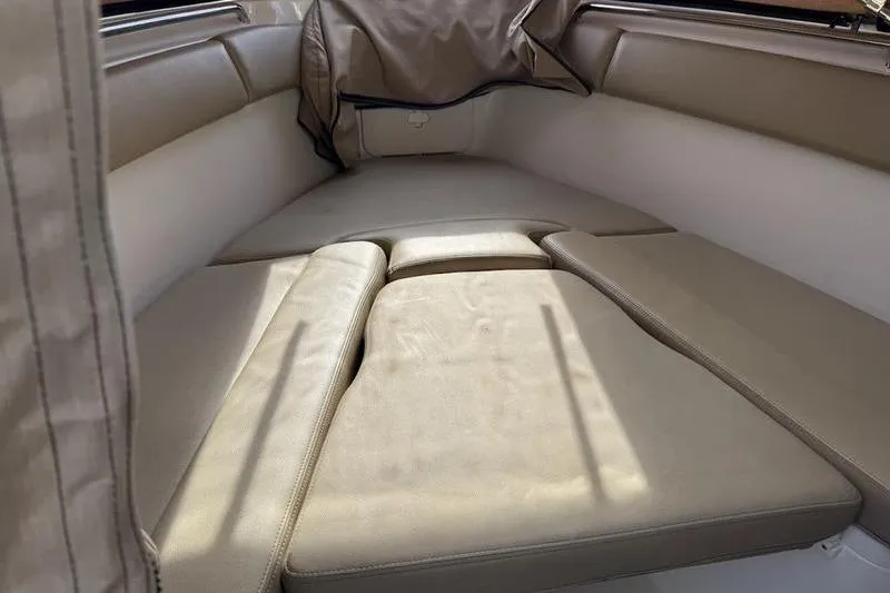 Slide: The Image of 2021 Sailfish 290 CC boat interior with beige cushioned seating. - 5