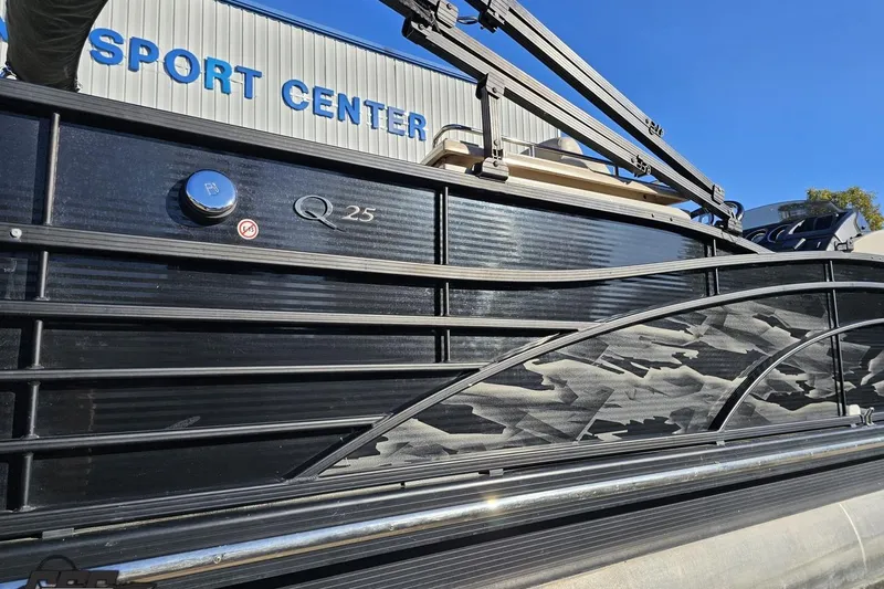 Slide: The Image of 2015 Bennington 2550 QBR boat at a sport center, showcasing sleek black design. - 10