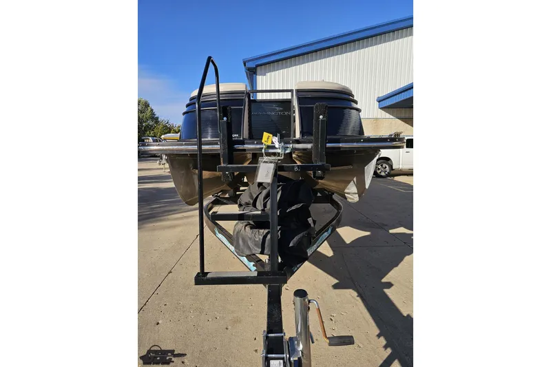 Slide: The Image of 2015 Bennington 2550 QBR pontoon boat on trailer, parked outdoors. - 17