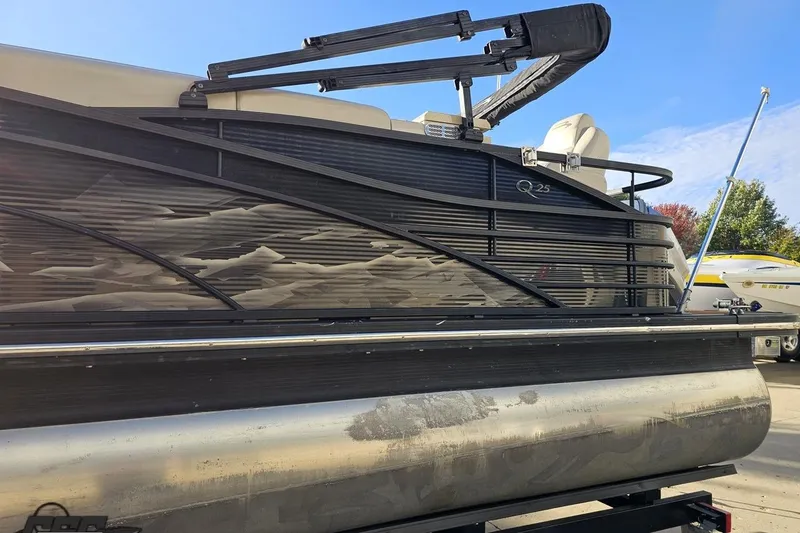 Slide: The Image of 2015 Bennington 2550 QBR pontoon boat side view with sleek design and modern features. - 27