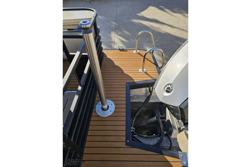Slide: The Image of 2015 Bennington 2550 QBR boat deck with ladder and engine view. - 38