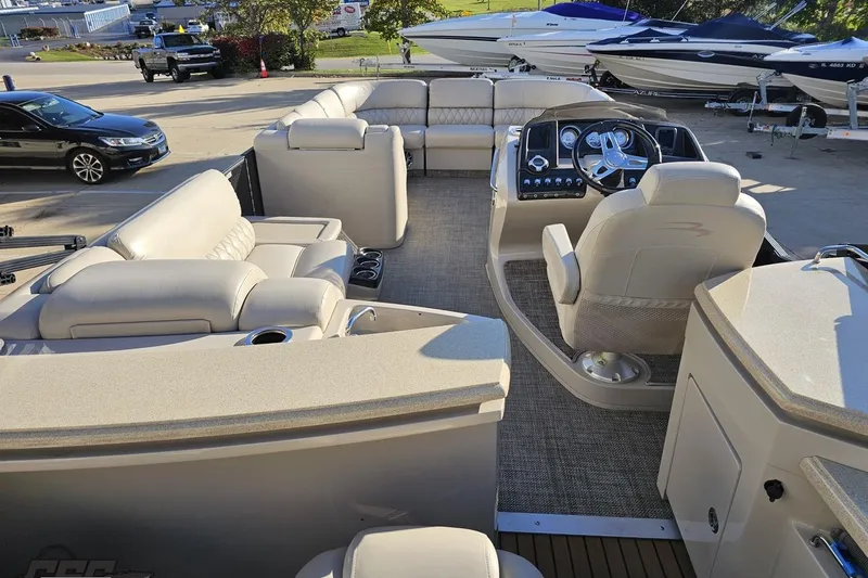 Slide: The Image of 2015 Bennington 2550 QBR pontoon boat interior with plush seating and modern dashboard. - 40