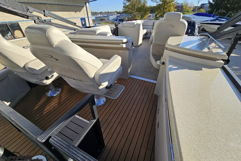 Slide: The Image of 2015 Bennington 2550 QBR boat interior with plush seating and sleek design. - 41