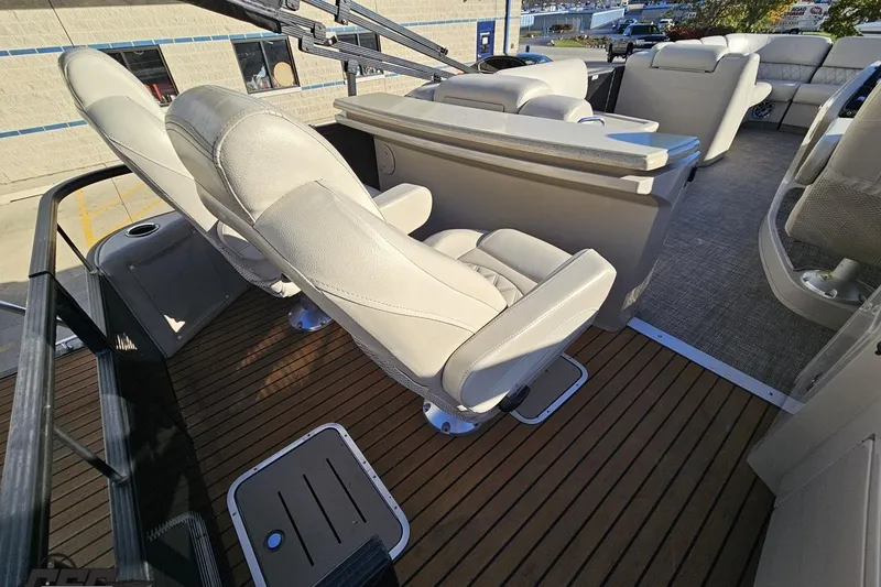 Slide: The Image of Luxurious seating on 2015 Bennington 2550 QBR boat with sleek design and wood flooring. - 42