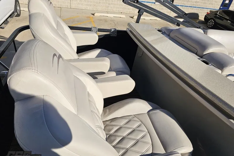 Slide: The Image of 2015 Bennington 2550 QBR boat interior with luxurious white seating and armrests. - 43