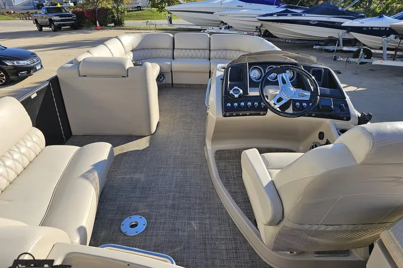 Slide: The Image of Luxurious interior of a 2015 Bennington 2550 QBR pontoon boat with plush seating and modern dashboard. - 46