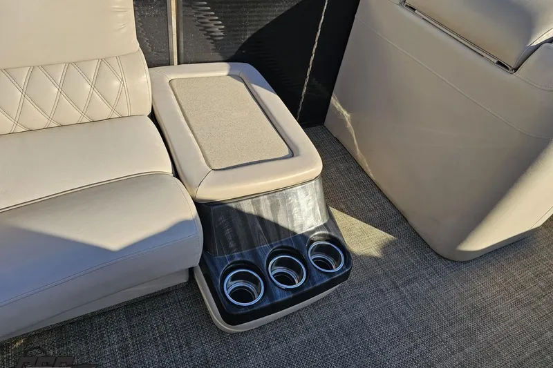 Slide: The Image of Luxurious seating and cup holders in 2015 Bennington 2550 QBR boat interior. - 52