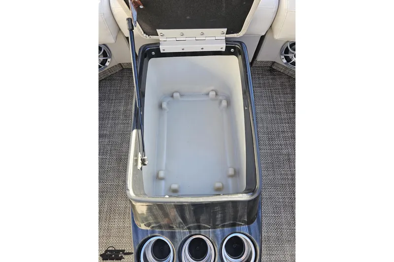Slide: The Image of Open storage compartment on 2015 Bennington 2550 QBR boat with cup holders. - 53
