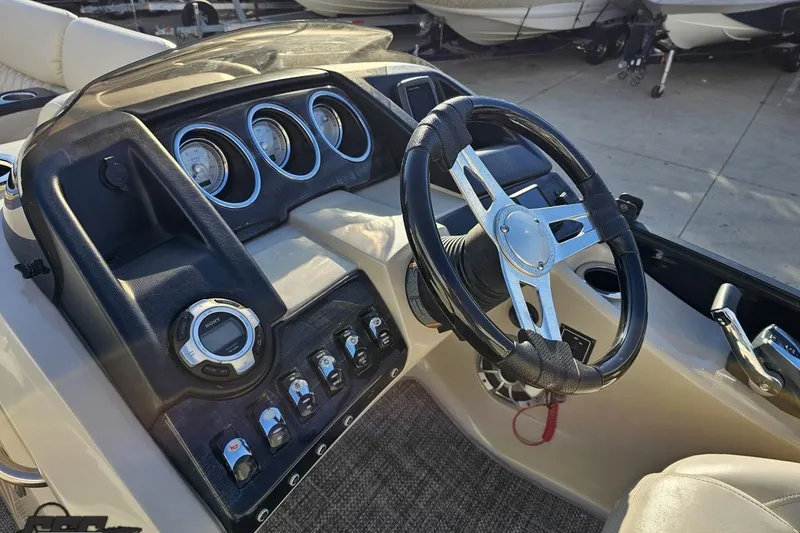 Slide: The Image of Steering console of a 2015 Bennington 2550 QBR boat with gauges and controls. - 57