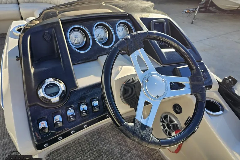 Slide: The Image of 2015 Bennington 2550 QBR boat dashboard with steering wheel and control panel. - 60