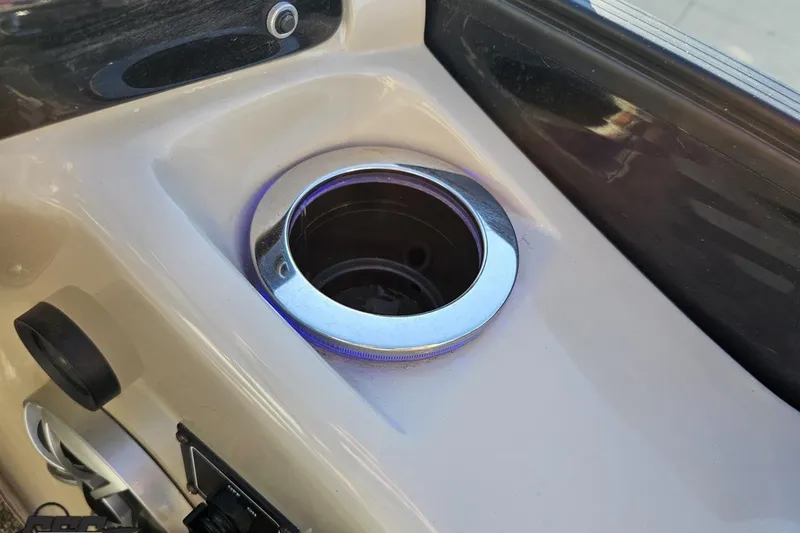 Slide: The Image of Cup holder on 2015 Bennington 2550 QBR boat, featuring sleek chrome trim. - 64