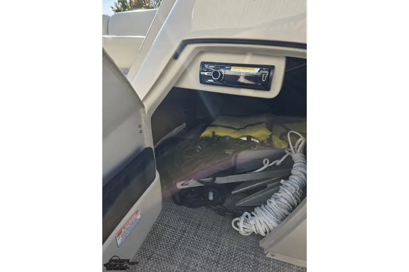 Slide: The Image of Storage compartment in a 2015 Bennington 2550 QBR boat with ropes and equipment. - 66