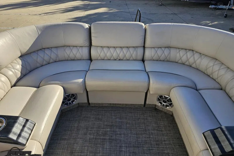 Slide: The Image of Luxurious seating on a 2015 Bennington 2550 QBR pontoon boat, featuring plush upholstery. - 69