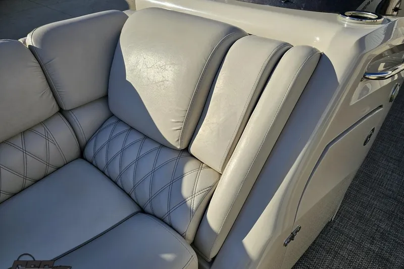 Slide: The Image of Luxurious seating on a 2015 Bennington 2550 QBR boat, featuring elegant stitching. - 70