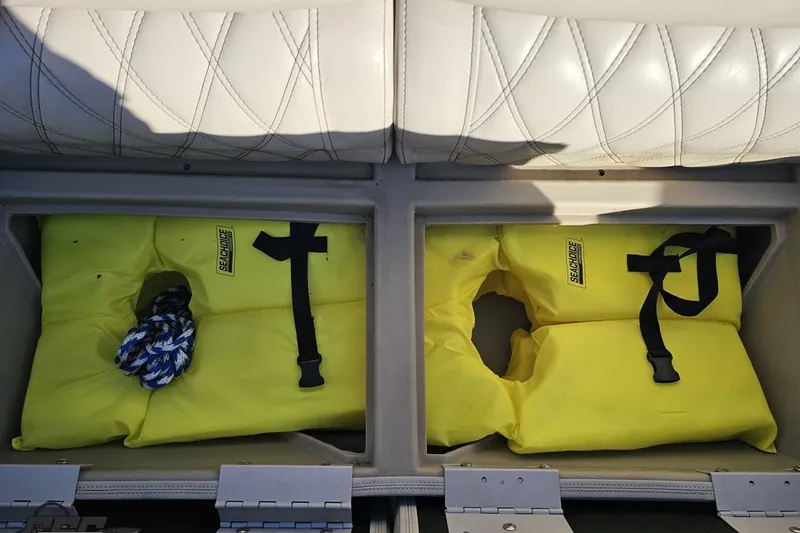 Slide: The Image of Yellow life jackets stored under seat on 2015 Bennington 2550 QBR boat. - 73