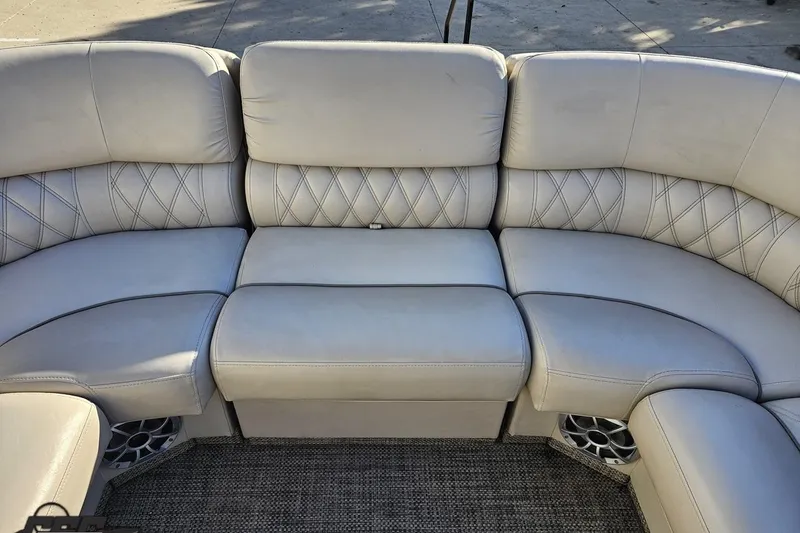 Slide: The Image of 2015 Bennington 2550 QBR boat seating with beige upholstery and diamond stitching. - 74