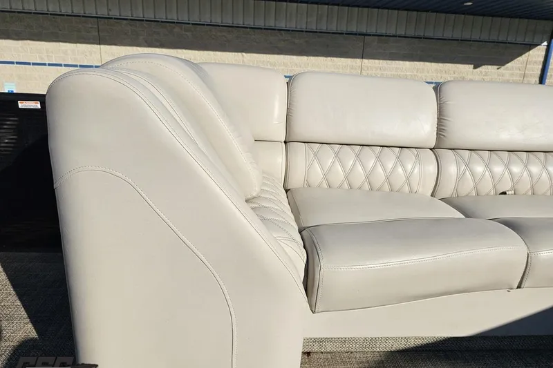 Slide: The Image of 2015 Bennington 2550 QBR boat seating with beige leather upholstery and diamond stitching. - 77
