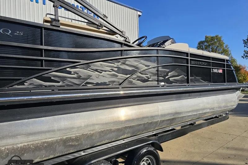 Slide: The Image of 2015 Bennington 2550 QBR pontoon boat on trailer, parked outdoors. - 8