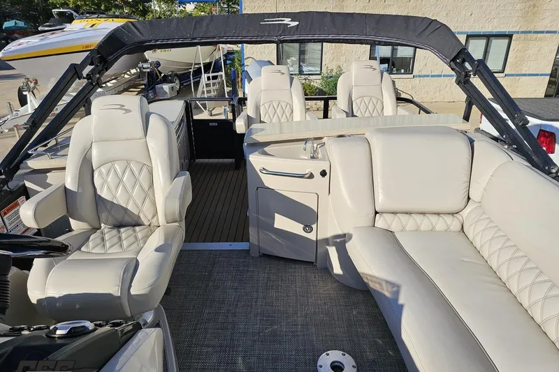 Slide: The Image of 2015 Bennington 2550 QBR boat interior with luxurious seating and sleek design. - 86