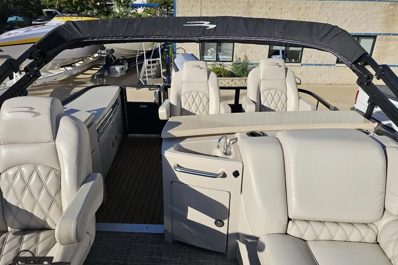 Slide: The Image of 2015 Bennington 2550 QBR boat interior with luxurious seating and sleek design. - 89