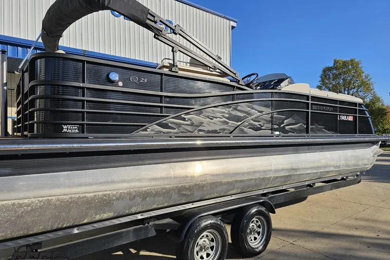 Slide: The Image of 2015 Bennington 2550 QBR pontoon boat on trailer, parked outdoors. - 9