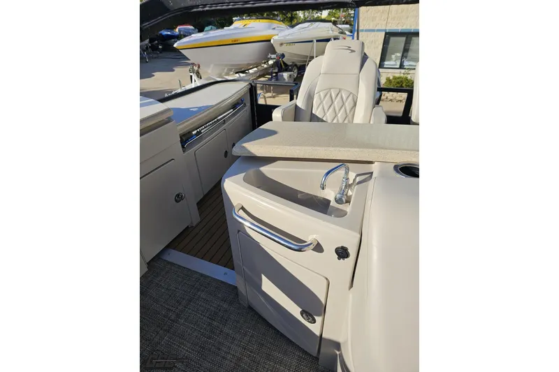 Slide: The Image of 2015 Bennington 2550 QBR boat interior with sink and seating area. - 91