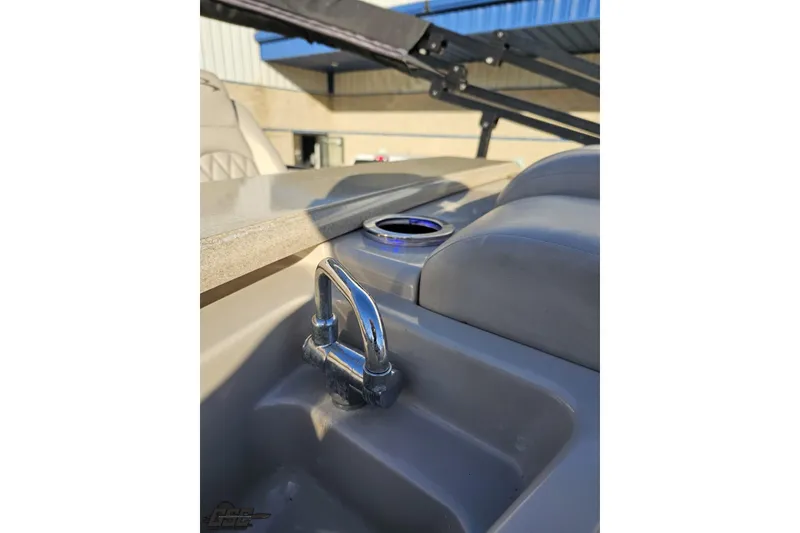 Slide: The Image of 2015 Bennington 2550 QBR boat interior with cup holder and chrome handle. - 94
