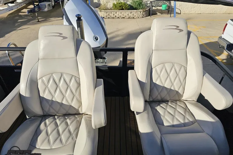 Slide: The Image of 2015 Bennington 2550 QBR boat seats with diamond-stitched upholstery and armrests. - 96