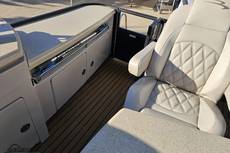 Slide: The Image of Luxurious interior of 2015 Bennington 2550 QBR boat with plush seating and sleek design. - 98