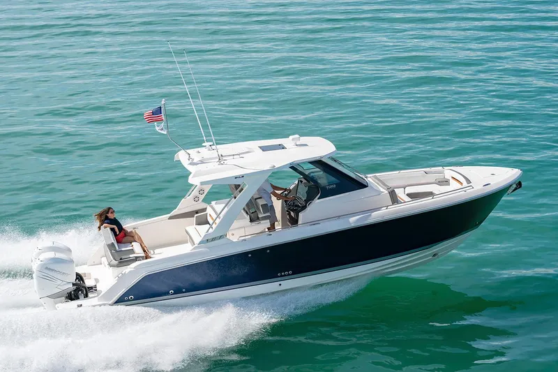 Slide: The Image of 2023 Tiara Yachts 34 LS boat docked under clear blue sky. - 1