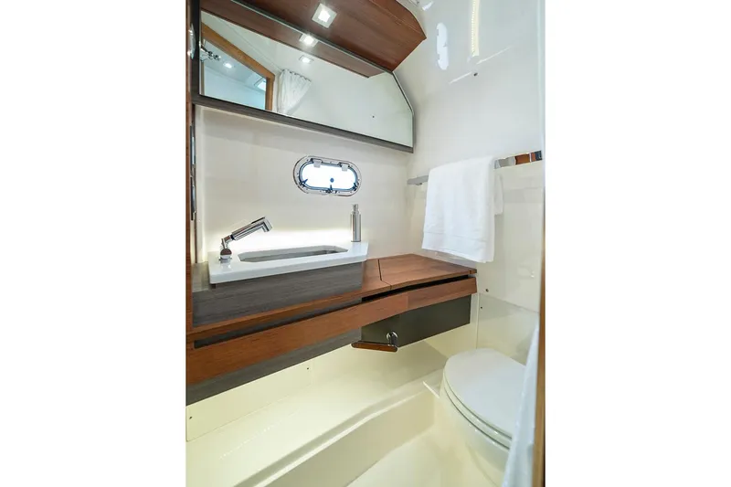 Slide: The Image of 2023 Tiara Yachts 34 LS throttle controls and dashboard details. - 16