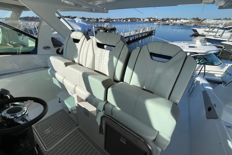 Slide: The Image of 2023 Tiara Yachts 34 LS interior with luxurious seating and scenic marina view. - 23