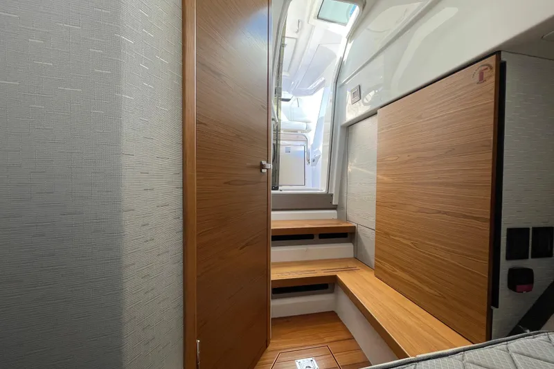 Slide: The Image of Interior of 2023 Tiara Yachts 34 LS, featuring wooden steps and modern design. - 26