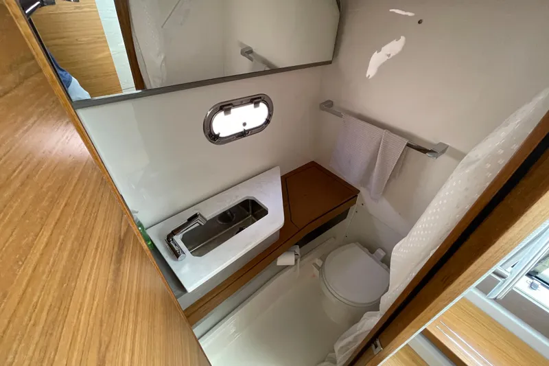 Slide: The Image of 2023 Tiara Yachts 34 LS bathroom interior with sink, toilet, and towel rack. - 28