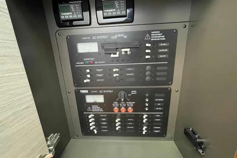 Slide: The Image of Electrical control panel on 2023 Tiara Yachts 34 LS, featuring AC and DC systems. - 30