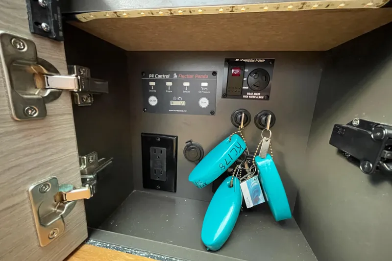 Slide: The Image of Control panel inside 2023 Tiara Yachts 34 LS, featuring keys and electrical outlet. - 31