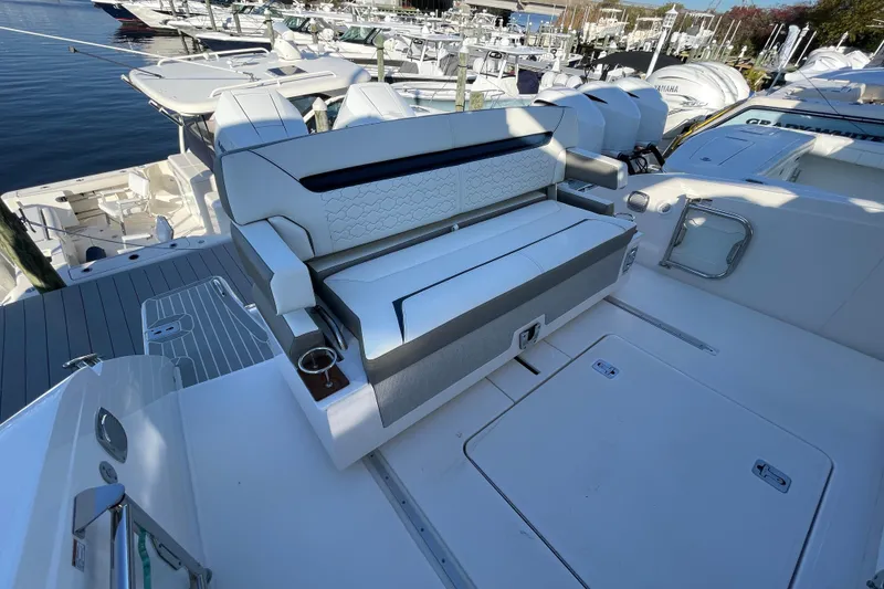 Slide: The Image of 2023 Tiara Yachts 34 LS luxury seating area at marina. - 36