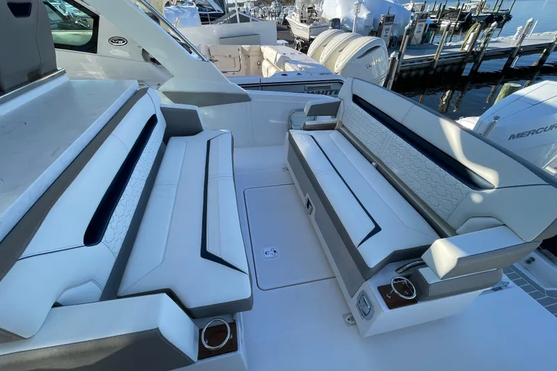 Slide: The Image of 2023 Tiara Yachts 34 LS interior seating with luxurious white upholstery and modern design. - 37