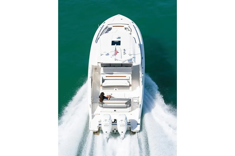 Slide: The Image of 2023 Tiara Yachts 34 LS with dual 400 V10 engines, docked under clear blue sky. - 4